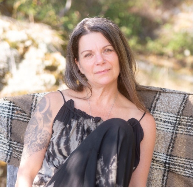 Kimberly Flear seated outdoors