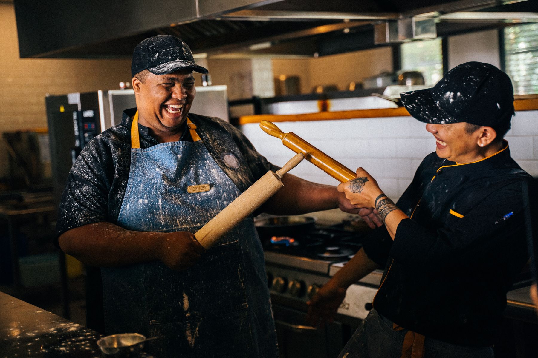 Kitchen team laughing together during a shift