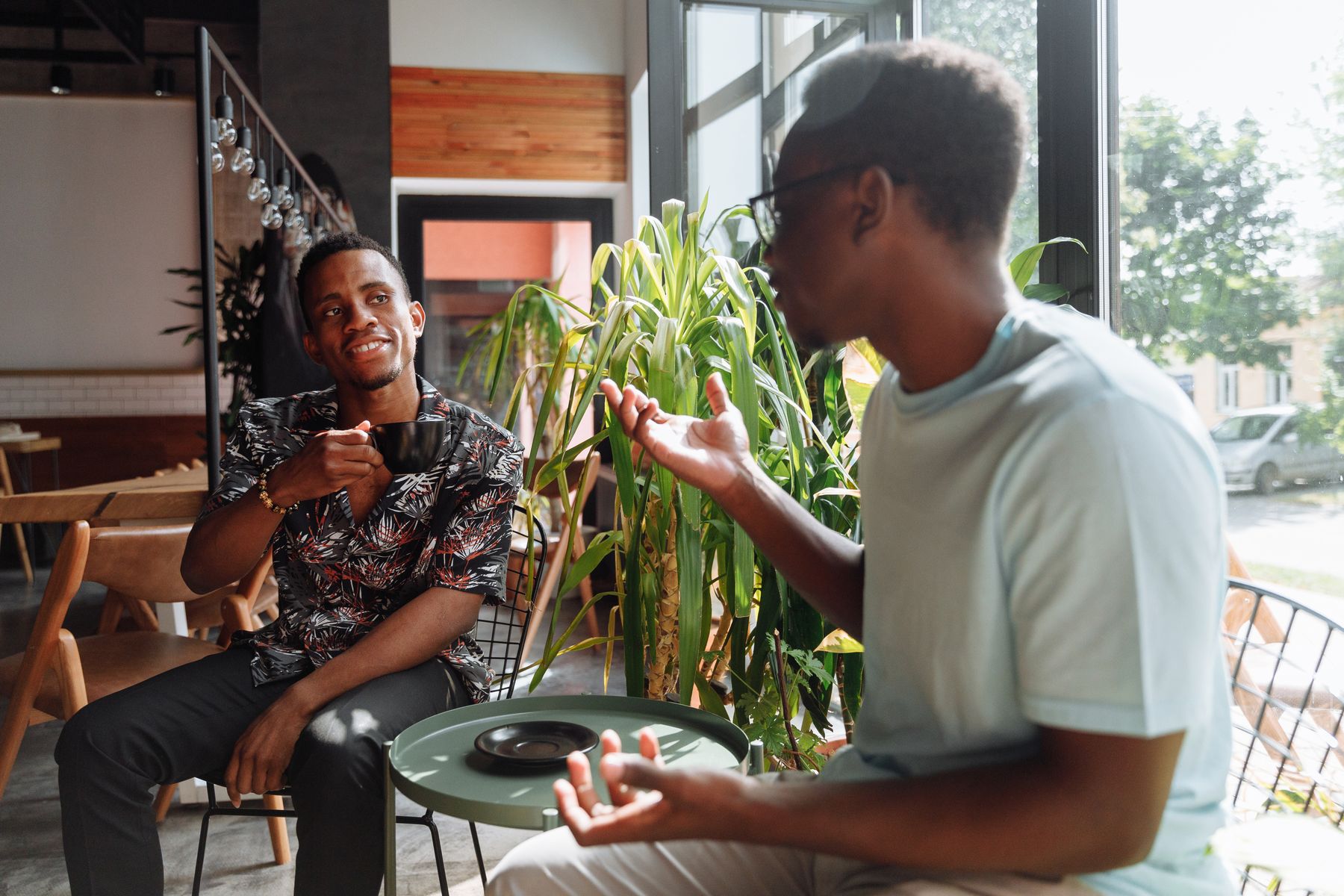 Two people in conversation over coffee